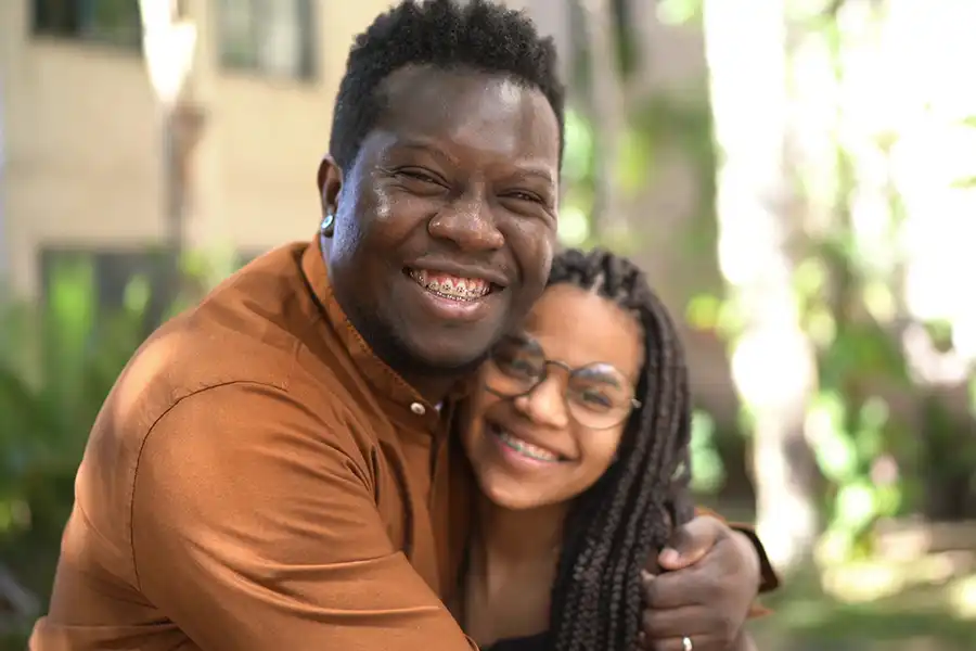 Father hugging daughter, both smiling