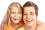 Close-up of smiling teenage girl and boy with healthy, bright smiles.