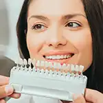 Dentist professional showing veneers, woman with beautiful teeth