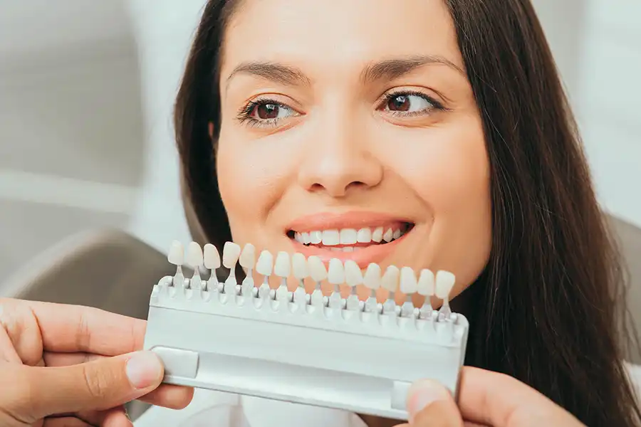 Dentist professional showing veneers, woman with beautiful teeth