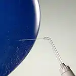 Waterpik™ water flosser spraying a balloon