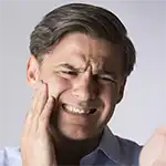 Man with tooth pain grimacing