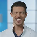 Dentist Dr. Chris Strandburg, smiling, wearing a white lab coat and black shirt