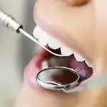 Woman's mouth being probed by dental professional