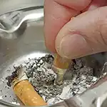 Man putting out his cigarette in an ashtray