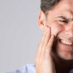 Man with tooth pain grimacing