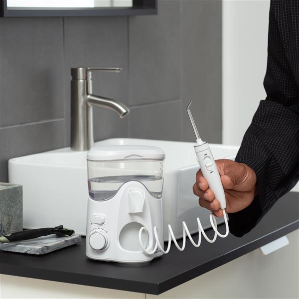 Hand Holding Handle of Ultra Plus Water Flosser WP-150 