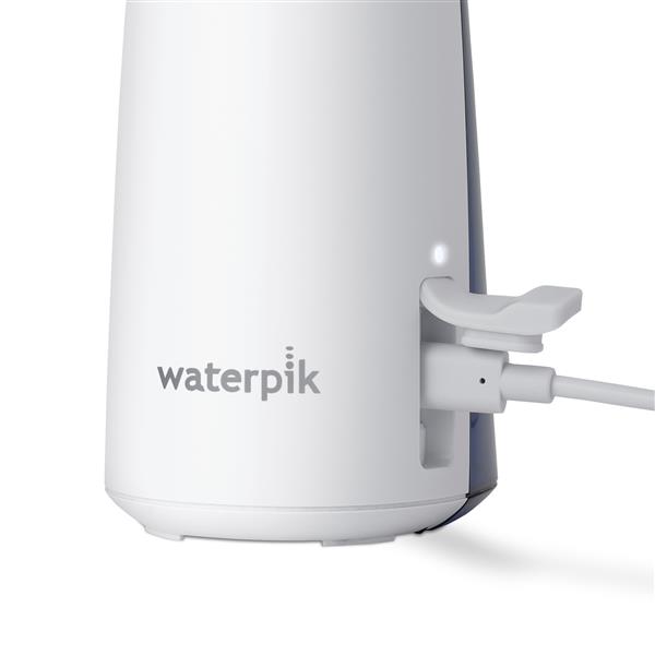 Charging port on the base of the White Cordless 1200 handheld water flosser.