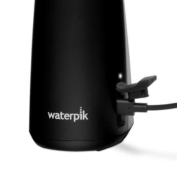 Charging port on the base of the Black Cordless Enhance 3200 handheld water flosser.
