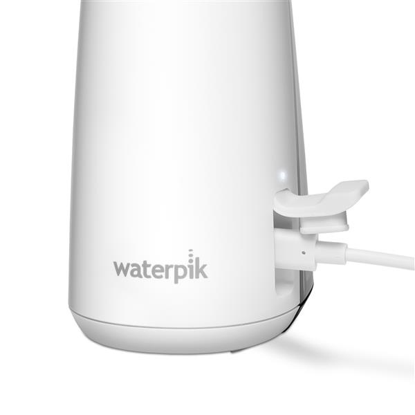 Charging port on the base of the White Cordless Enhance 3200 handheld water flosser.