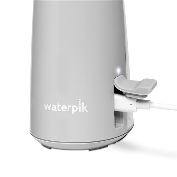Charging port on the base of the Gray Cordless handheld water flosser.