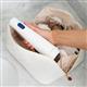 White Cordless 1200 handheld water flosser, without tip, taken out of a toiletry bag.