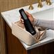 Black Cordless Enhance 3200 handheld water flosser, without tip, taken out of a toiletry bag.