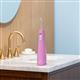 Mauve Cordless Pulse 3100 handheld water flosser on a bathroom sink.