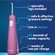 Mauve Cordless Pulse 3100 handheld water flosser features: 2 specialty tips, 2 pressure settings, use in the shower, 45 seconds of water capacity, and 9 weeks of use per charge.
