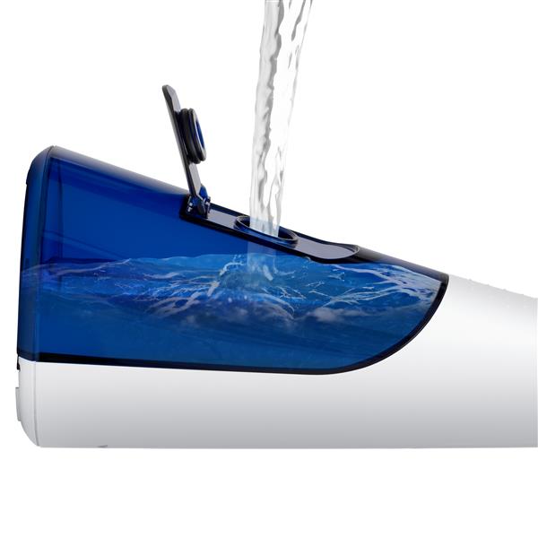 Filling the blue water reservoir of the White Cordless 1200 handheld water flosser.