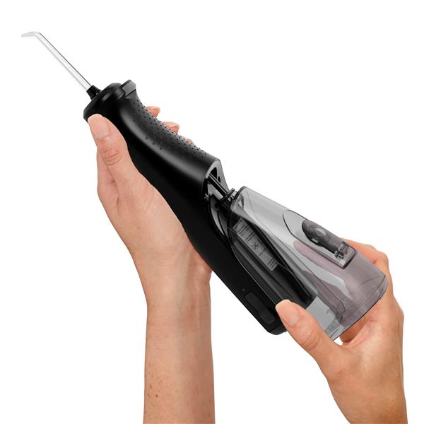 Sliding the water reservoir to remove it from the Black Cordless Enhance 3200 water flosser handle.