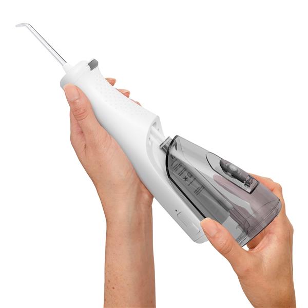 Sliding the water reservoir to remove it from the White Cordless Enhance 3200 water flosser handle.