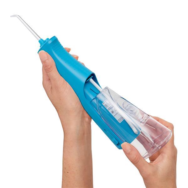 Sliding the water reservoir to remove it from the cyan Cordless Pulse 3100 water flosser handle.