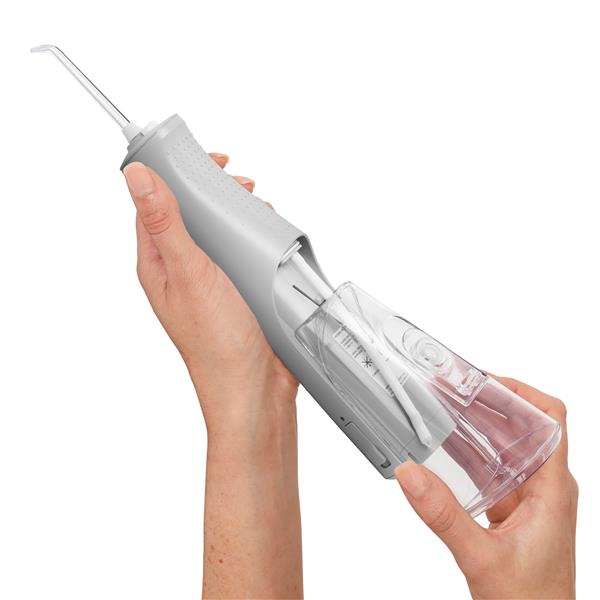 Sliding the water reservoir to remove it from the Gray Cordless water flosser handle.