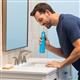 Cyan Cordless Pulse 3100 handheld water flosser in use, with person leaning over the bathroom sink.