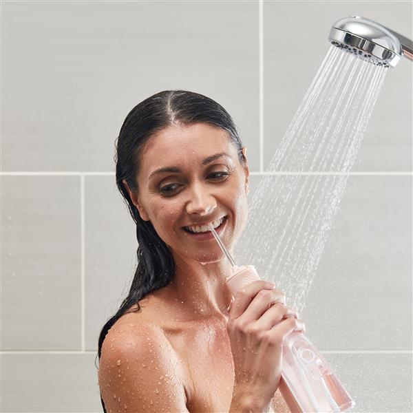 Using Pink Cordless Revive Water Flosser WF-03 in Shower