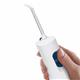White Cordless 1200 handheld water flosser handle, shown held in a hand for scale.