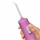 Mauve Cordless Pulse 3100 handheld water flosser handle and tip, shown held in a hand for scale.