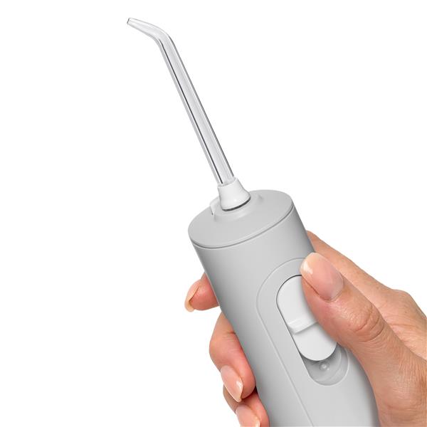 Gray Cordless handheld water flosser held vertically above bathroom sink.