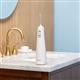 White Cordless 1100 handheld water flosser on a bathroom sink.