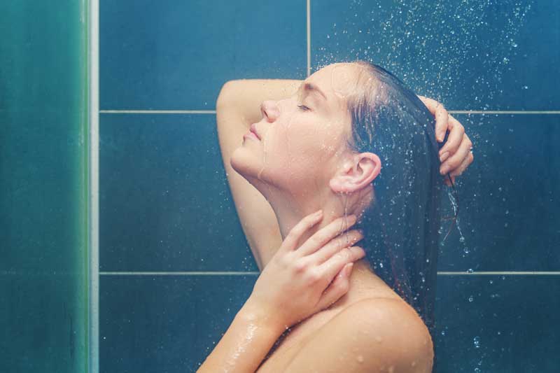 Benefits of a hot shower include massaging away body aches